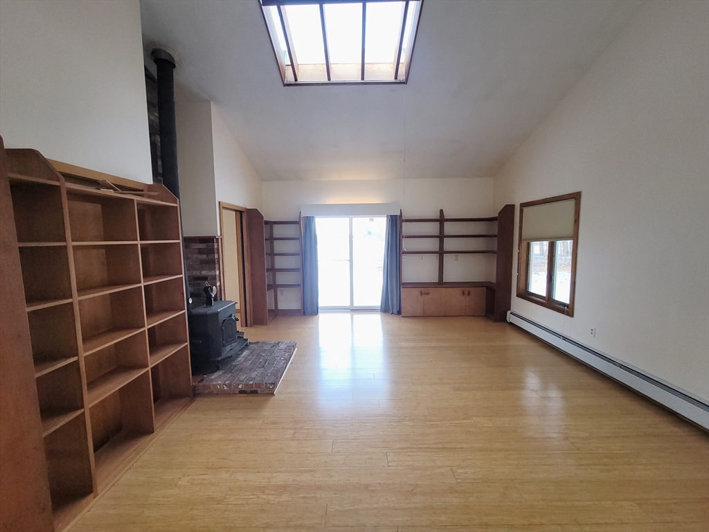 46 Long Hill Road, Unit RIGHT Groton, MA 01450 - Photo 6 of 30 an empty room with windows and cabinet