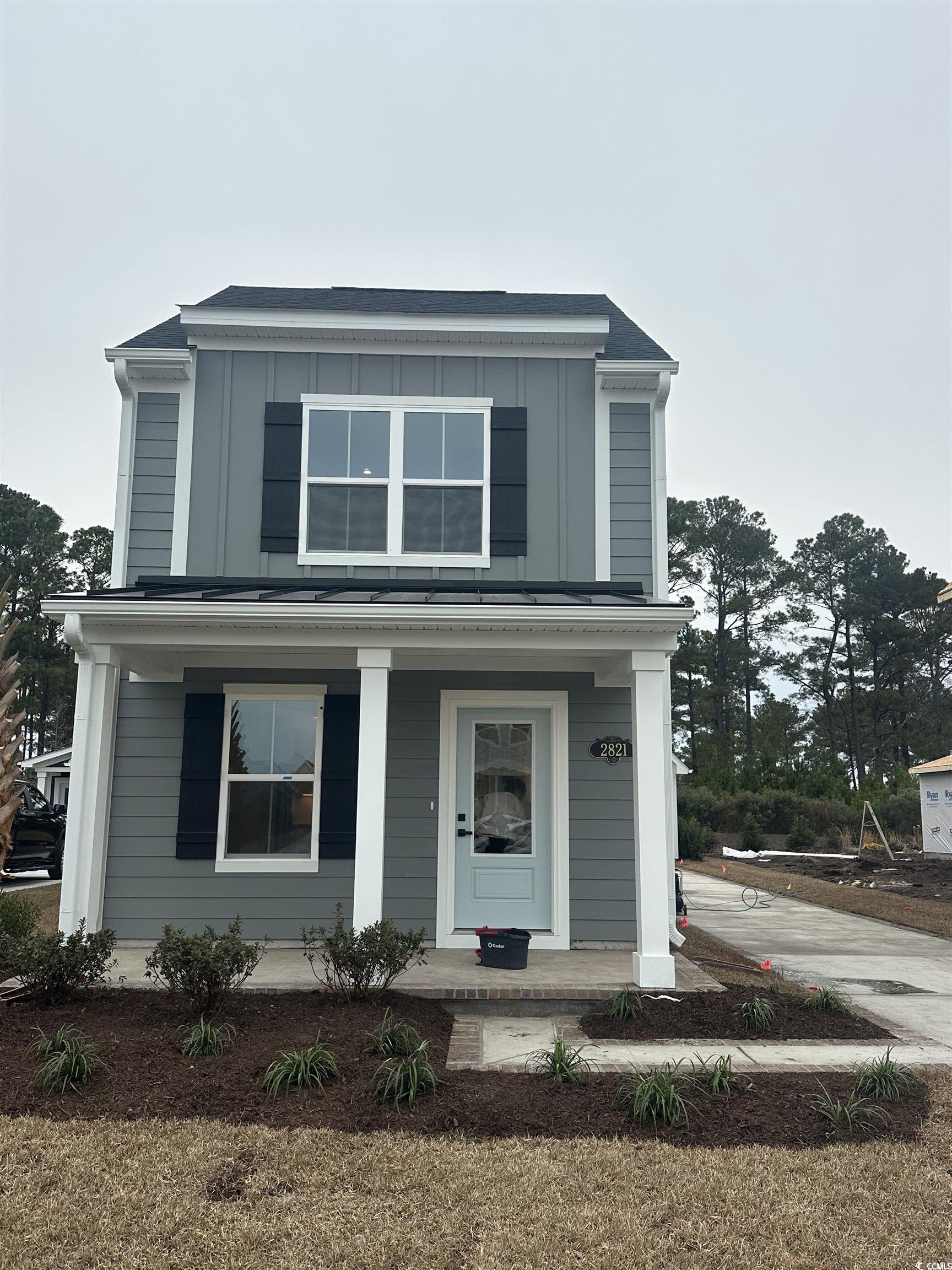 2821 Rowyn Street Longs, SC 29568 - Photo 1 of 14 View of front of house with covered porch and board and batten siding