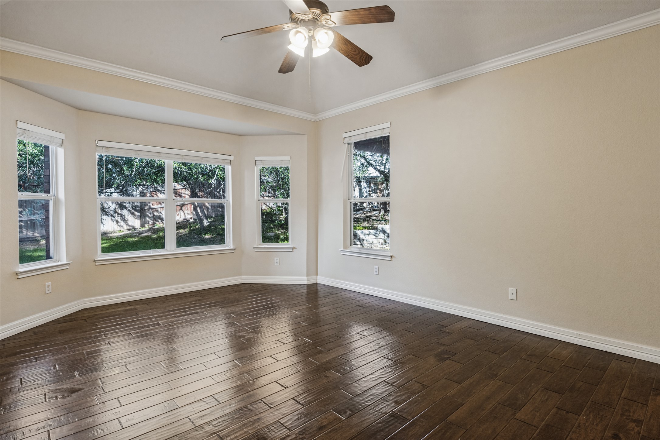 2832 Grimes Ranch Road Austin, TX 78732 - Photo 13 of 23 Rich hardwood flooring and crown molding define this versatile living space filled with natural light.