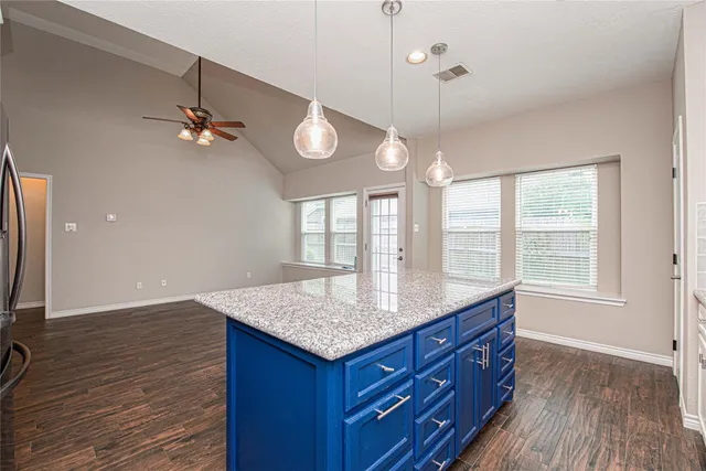 a bathroom with a granite countertop sink window and a mirror