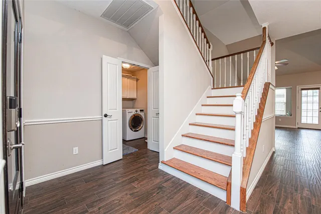a view of entryway with wooden floor and stairs