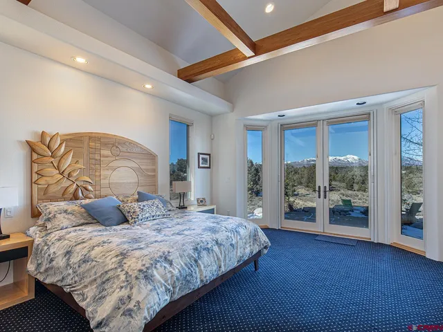 a bedroom with a large bed and a large window