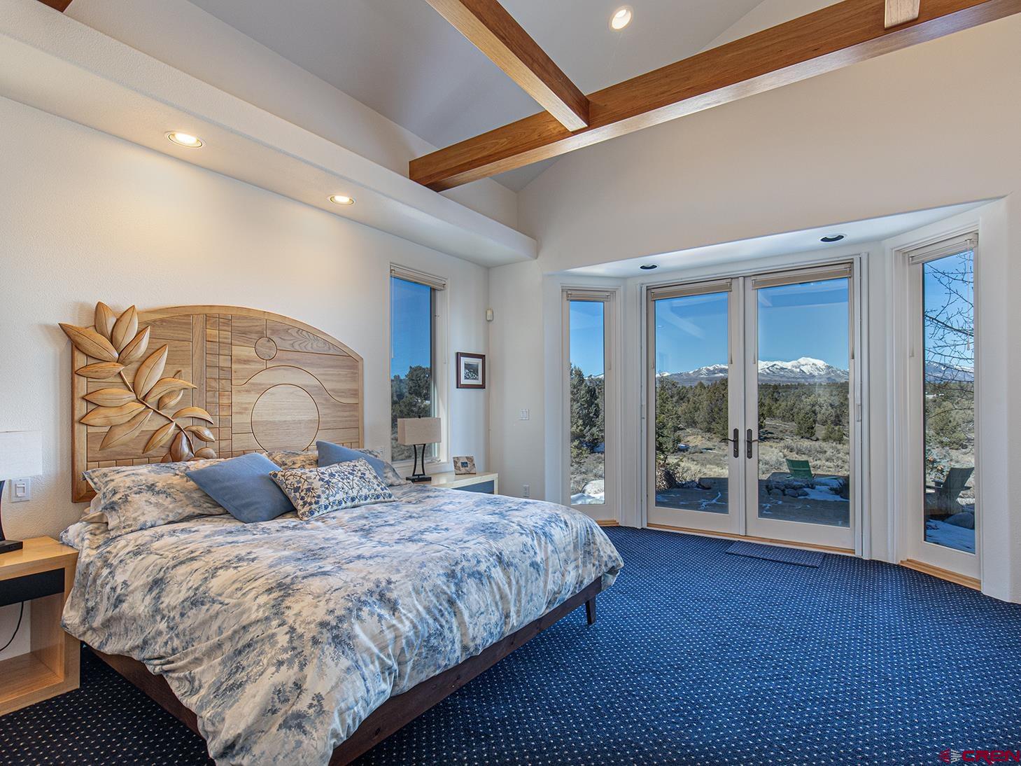 550 Wildcat Trail Hesperus, CO 81326 - Photo 12 of 27 a bedroom with a large bed and a large window