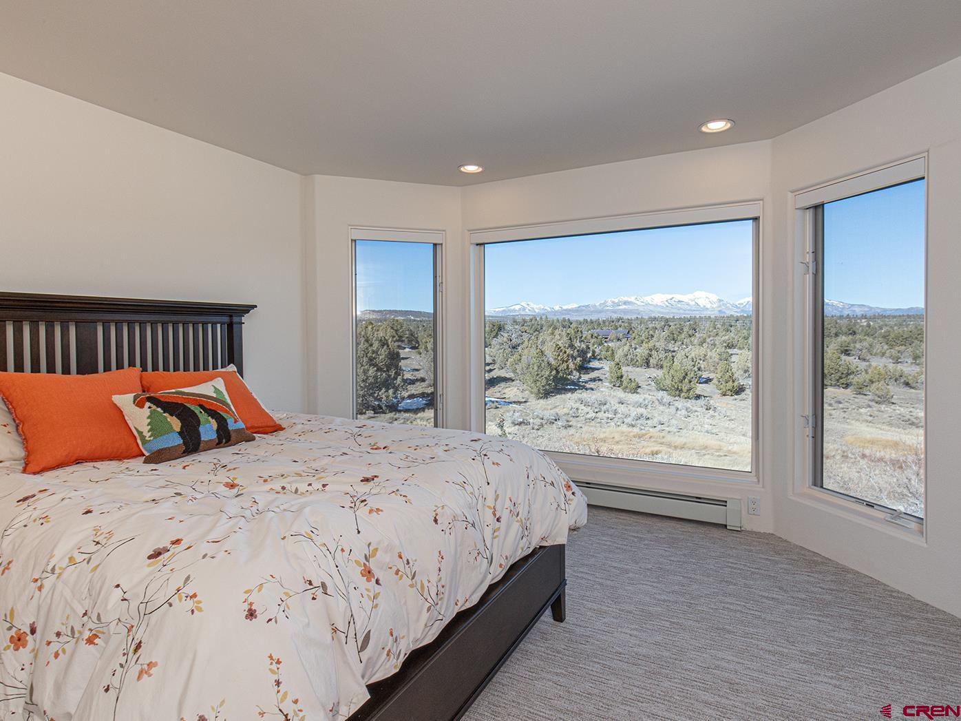 550 Wildcat Trail Hesperus, CO 81326 - Photo 16 of 27 a bedroom with a large bed and a large window