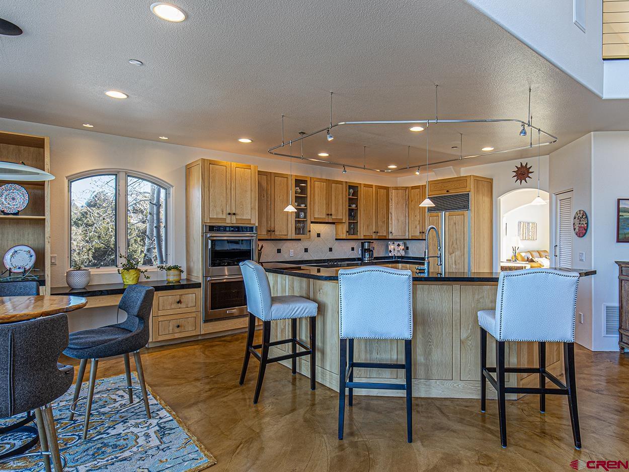 550 Wildcat Trail Hesperus, CO 81326 - Photo 5 of 27 a dining room with kitchen island furniture a large window and kitchen view