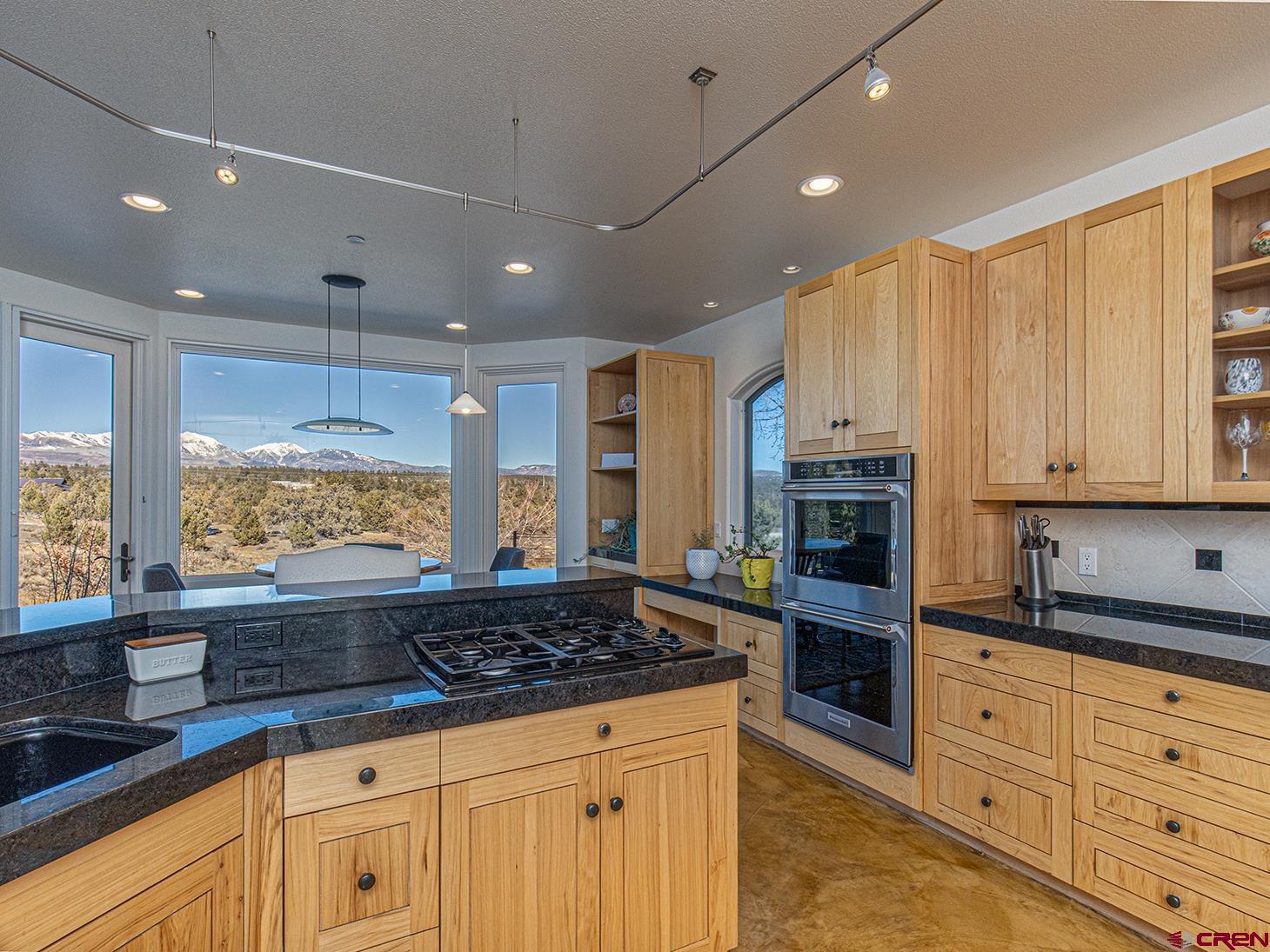 550 Wildcat Trail Hesperus, CO 81326 - Photo 6 of 27 a large kitchen with kitchen island granite countertop a large window and stainless steel appliances