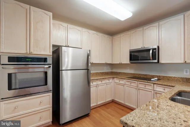 a kitchen with a sink and steel stainless steel appliances