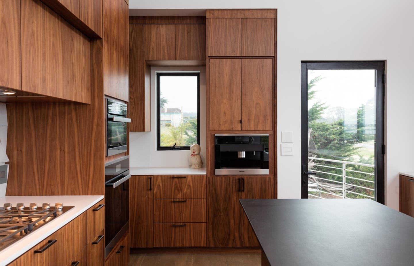 311 Magellan Avenue Half Moon Bay, CA 94019 - Photo 13 of 37 a kitchen with windows and a refrigerator