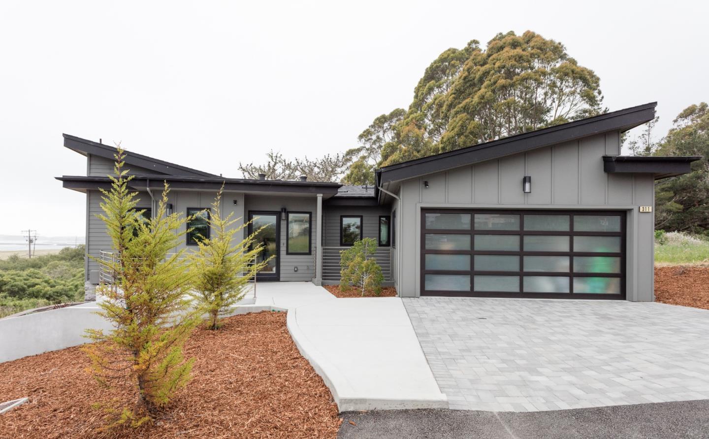 311 Magellan Avenue Half Moon Bay, CA 94019 - Photo 3 of 37 a front view of a house with garden