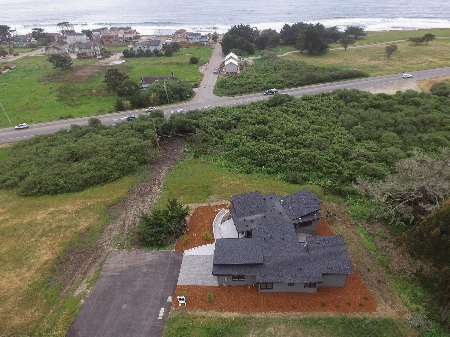 311 Magellan Avenue Half Moon Bay, CA 94019 - Photo 31 of 37 an aerial view of a house with a garden and lake view