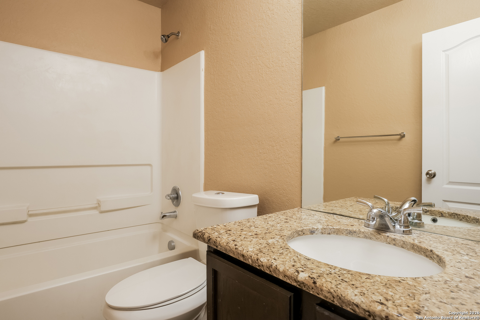 3415 Dunlap Fields Converse, TX 78109 - Photo 13 of 17 a bathroom with a granite countertop toilet sink and mirror