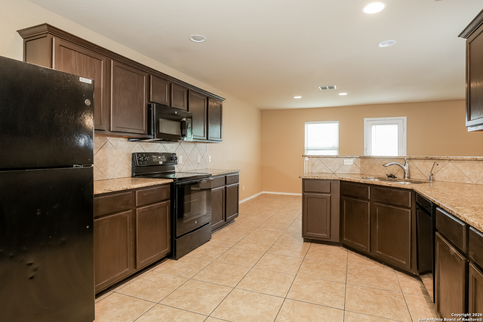 3415 Dunlap Fields Converse, TX 78109 - Photo 7 of 17 a kitchen with stainless steel appliances granite countertop a refrigerator and a stove top oven