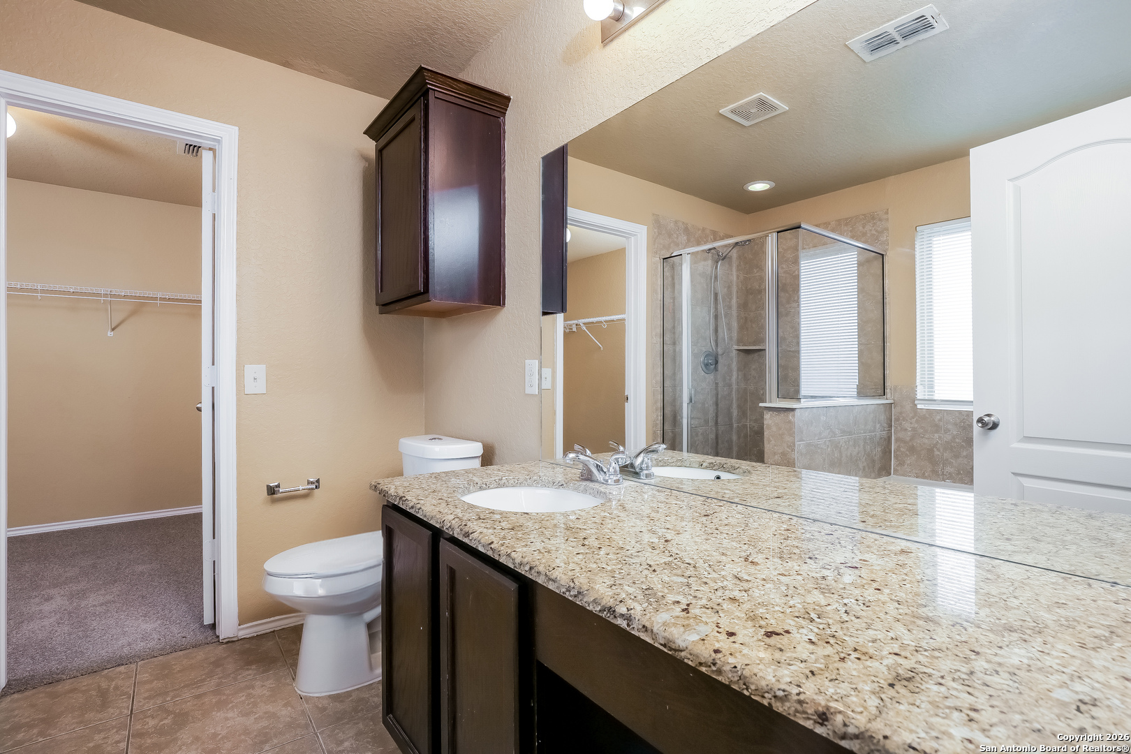 3415 Dunlap Fields Converse, TX 78109 - Photo 9 of 17 a bathroom with a granite countertop sink toilet and shower