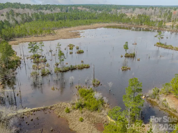 a view of a lake with houses in the back