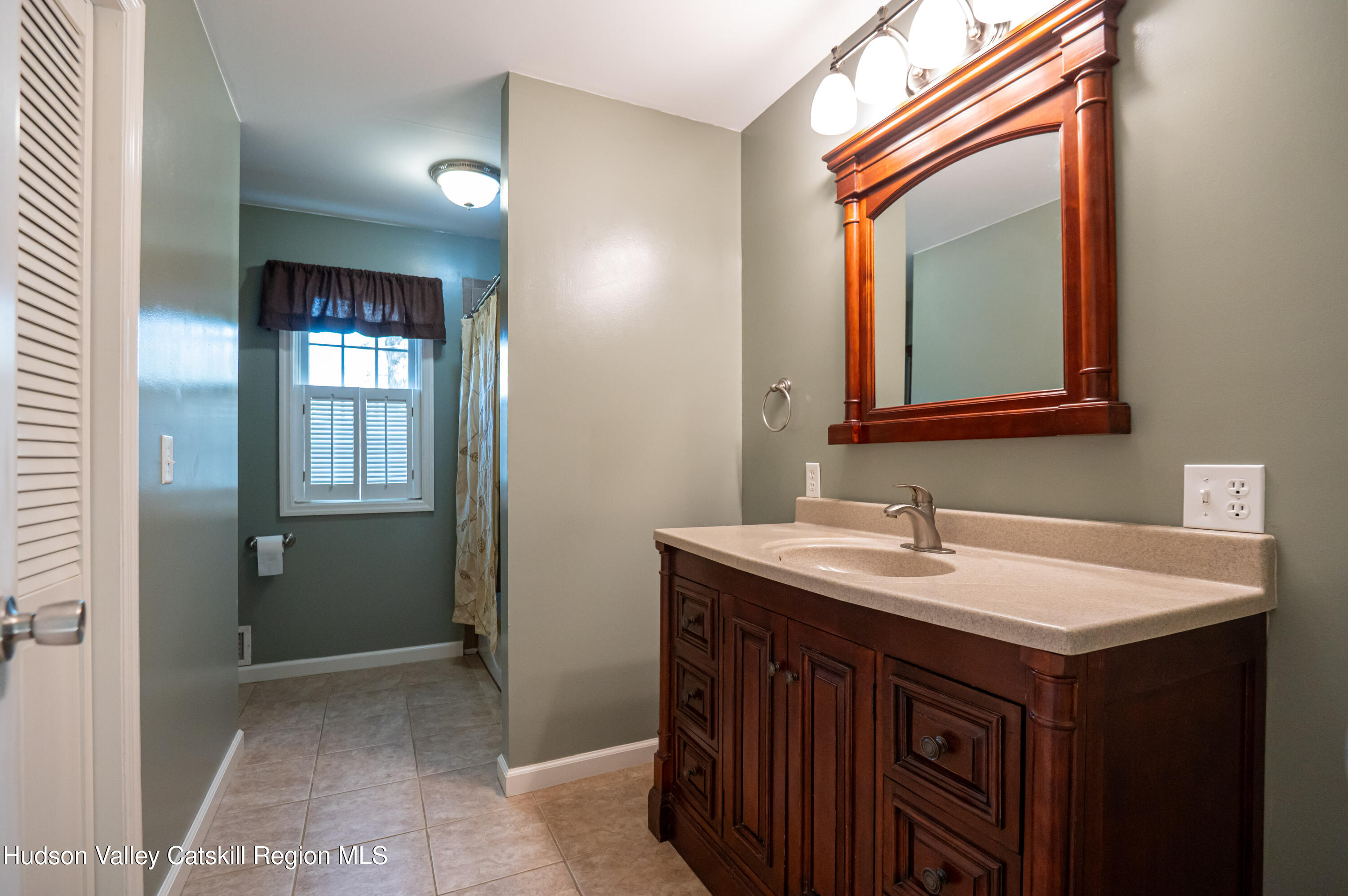 59 Hawley Road Niverville, NY 12130 - Photo 11 of 20 a bathroom with a sink and a mirror