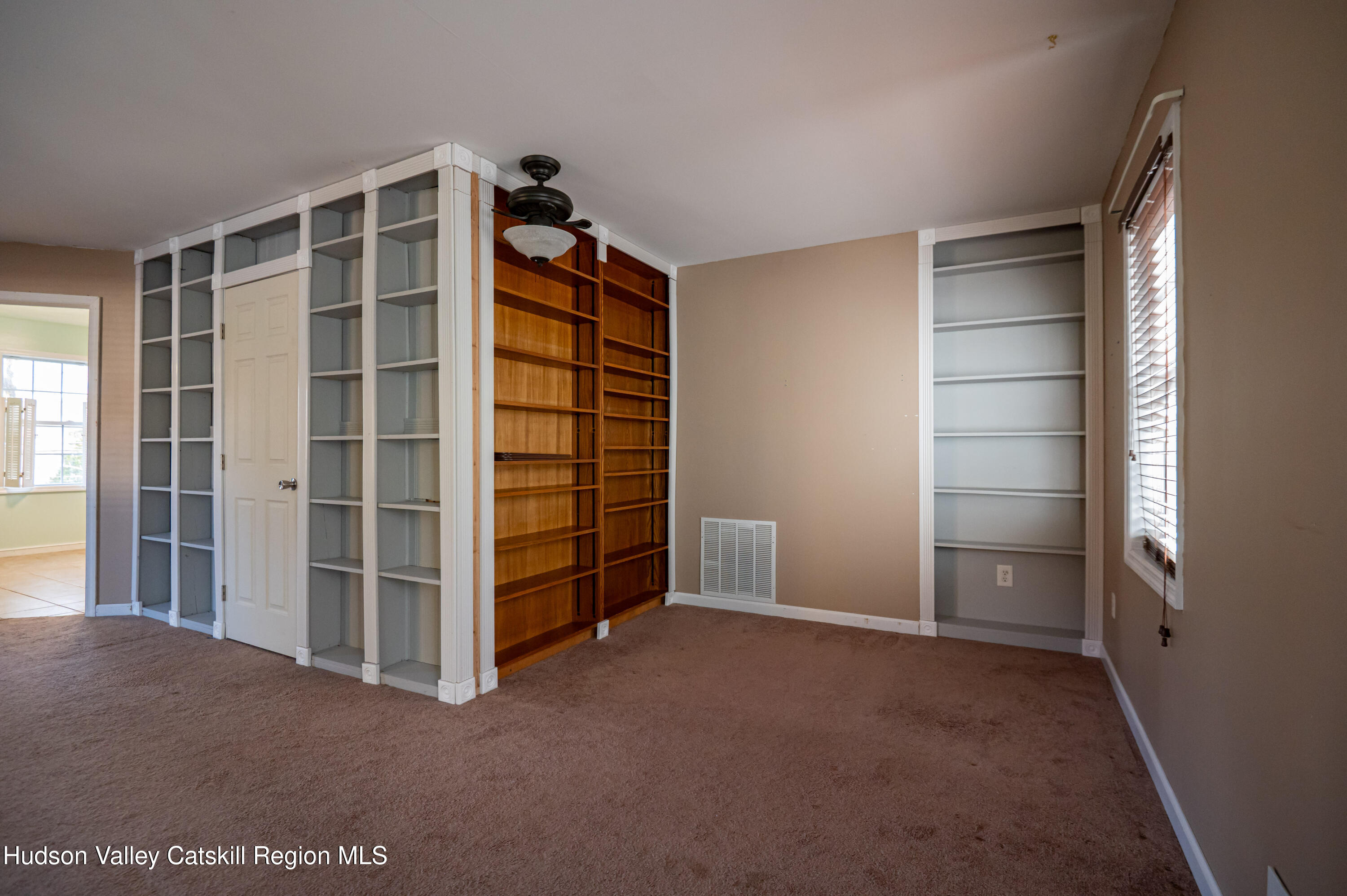 59 Hawley Road Niverville, NY 12130 - Photo 16 of 20 a view of an empty room with furniture and a window