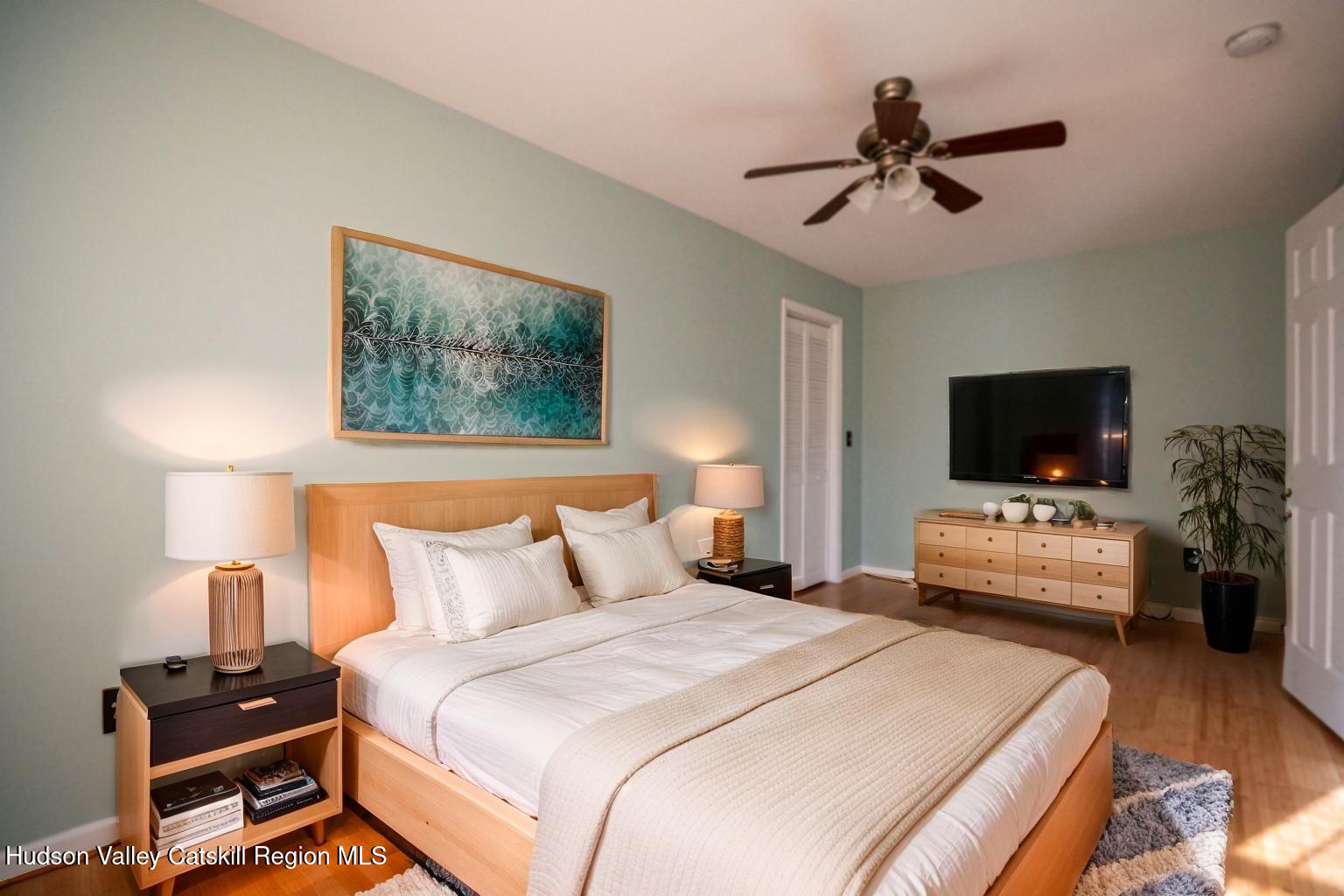 59 Hawley Road Niverville, NY 12130 - Photo 7 of 20 a bedroom with a bed and a flat screen tv