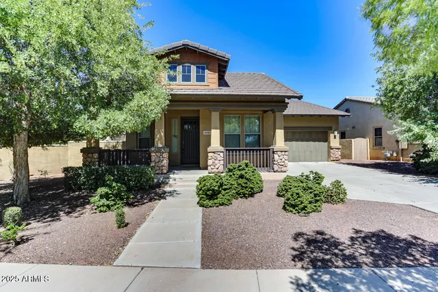 a front view of a house with a yard and outdoor seating