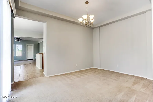 a view of a chandelier in big room and chandelier