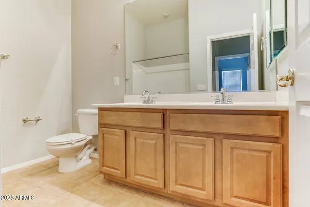 a bathroom with a sink toilet and mirror
