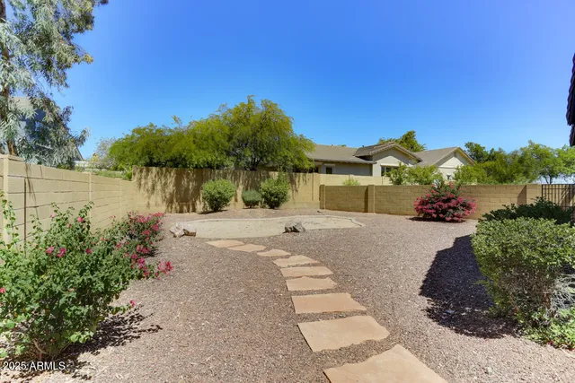 a pathway of a house with a yard