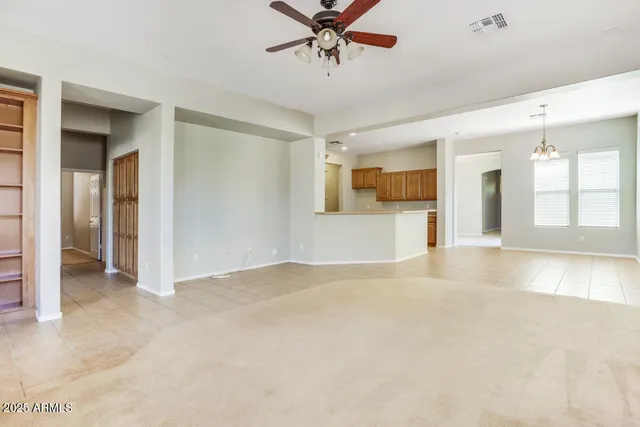 a view of a livingroom with a ceiling fan and window