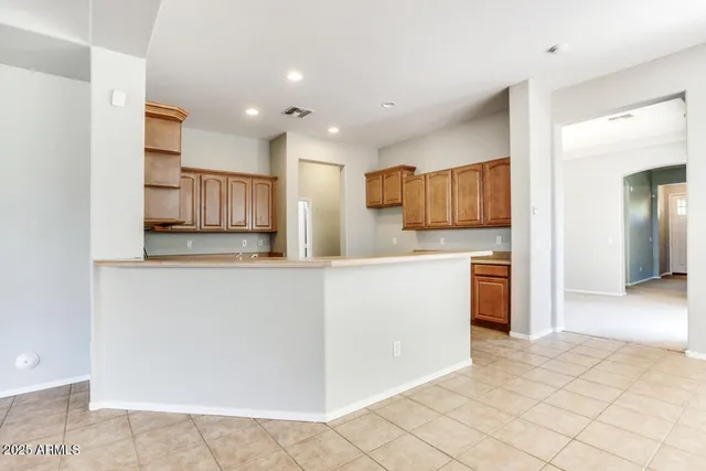 a kitchen with granite countertop a refrigerator and a sink