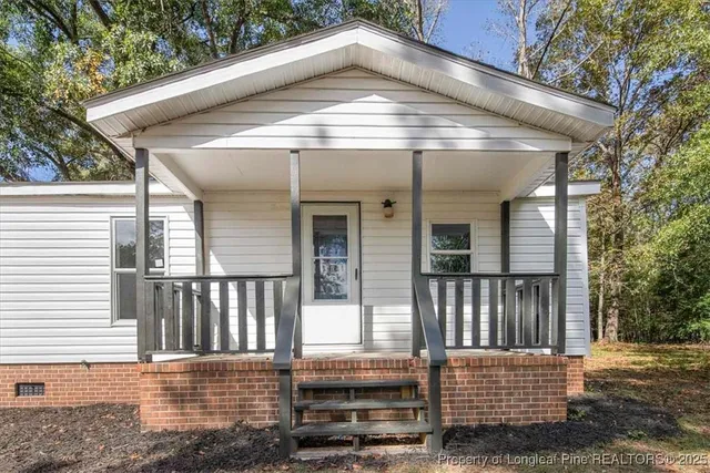 a view of a house with a small deck