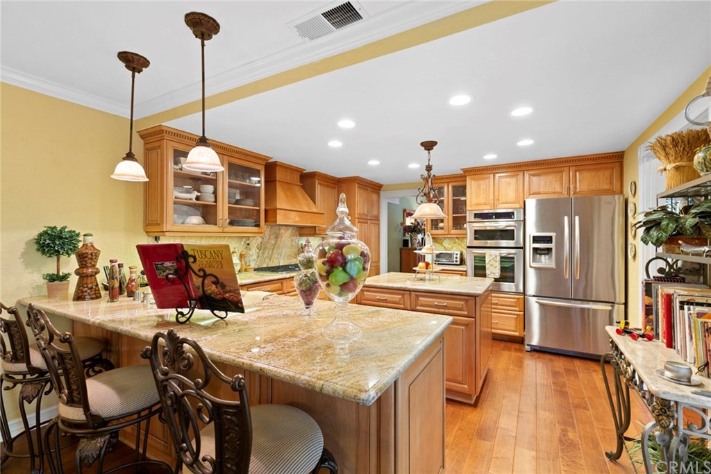535 Riviera Court Fullerton, CA 92835 - Photo 1 of 1 Kitchen remodeled- stainless appliances including a wine refrigerator. Custom cabinets, pendant lighting, recessed lighting, 5 burner cooktop and beautiful distressed wood flooring.