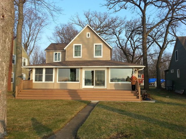 a front view of a house with swimming pool having outdoor seating