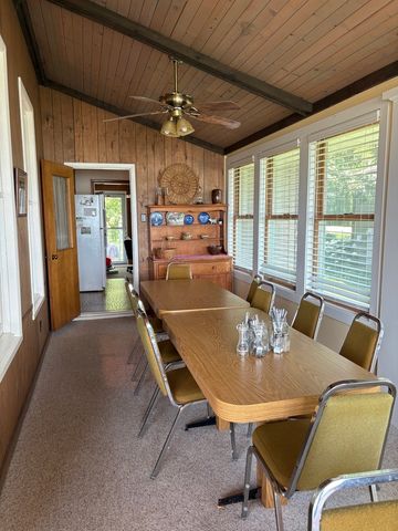 a dining room with furniture a chandelier and window