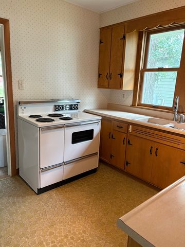 a kitchen with a sink cabinets and appliances