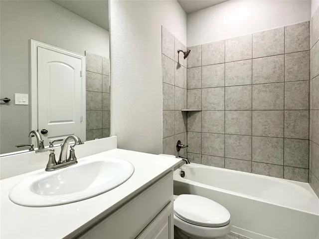 a bathroom with a sink a toilet and bathtub