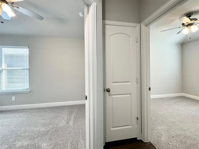 an empty room with windows and closet