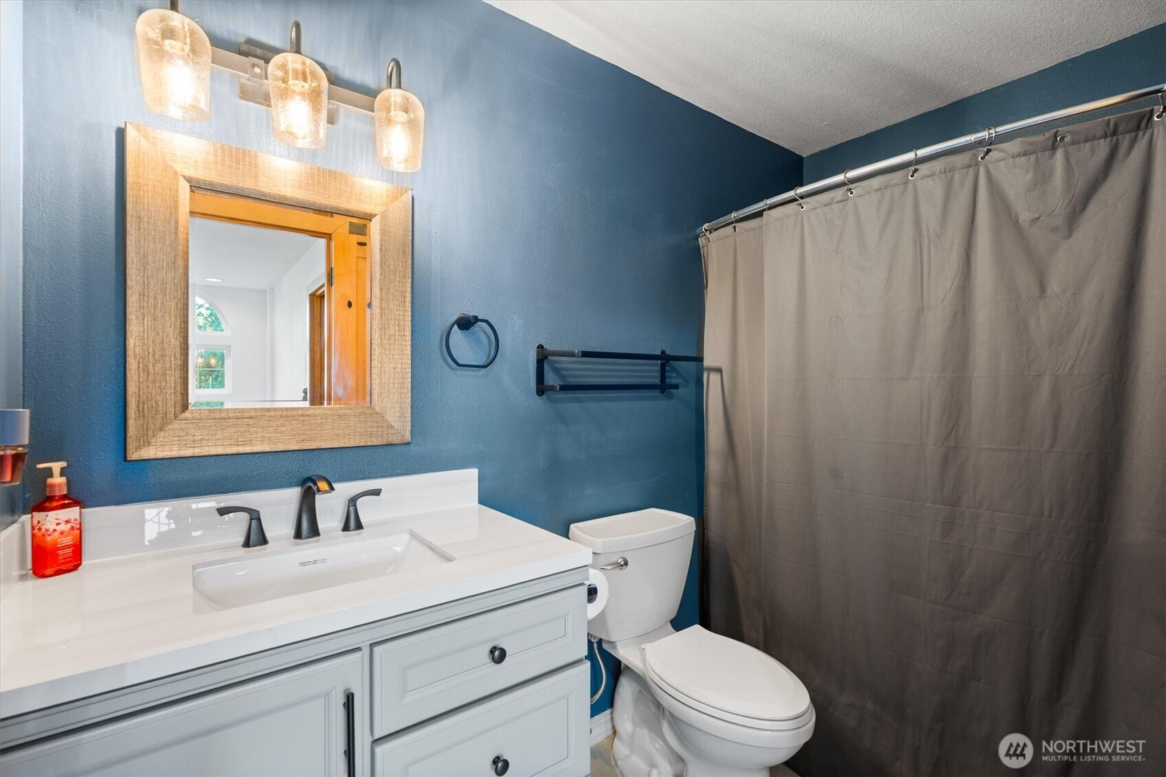 508 Caldwell Road Castle Rock, WA 98611 - Photo 24 of 40 a bathroom with a sink a toilet and a mirror