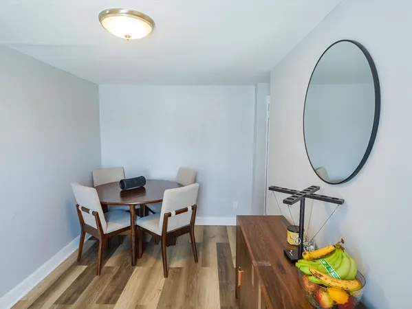 a view of a dining room with furniture and a mirror