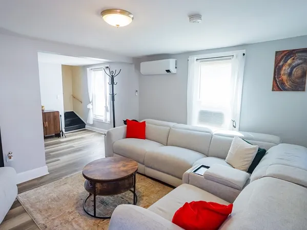 a living room with furniture and a rug