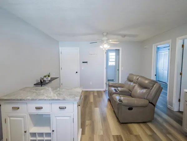 a living room with furniture and a chandelier