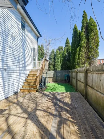 a view of a house with backyard and trees