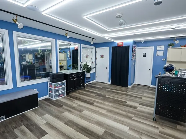a room with wooden floor and furniture