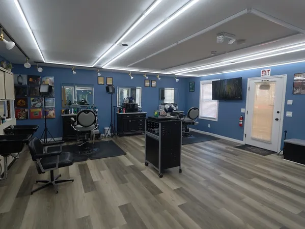 a view of a room with gym equipment and wooden floor