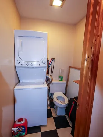 a bathroom with a toilet and a mirror