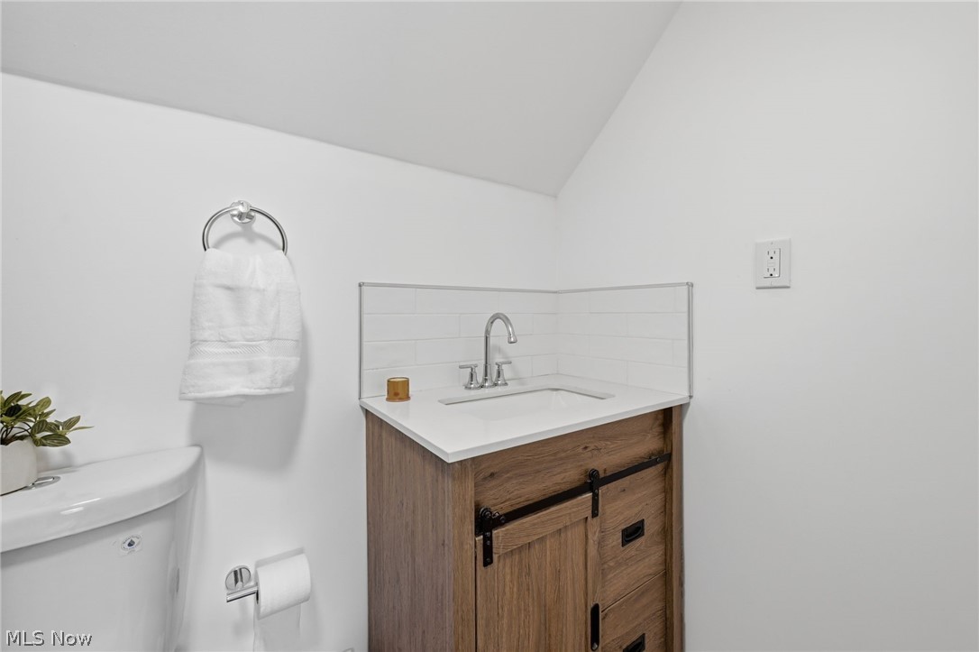 951 Bey Road Akron, OH 44312 - Photo 19 of 34 Second floor bathroom with white vanity with a wood-finish base, integrated sink, and white countertop
