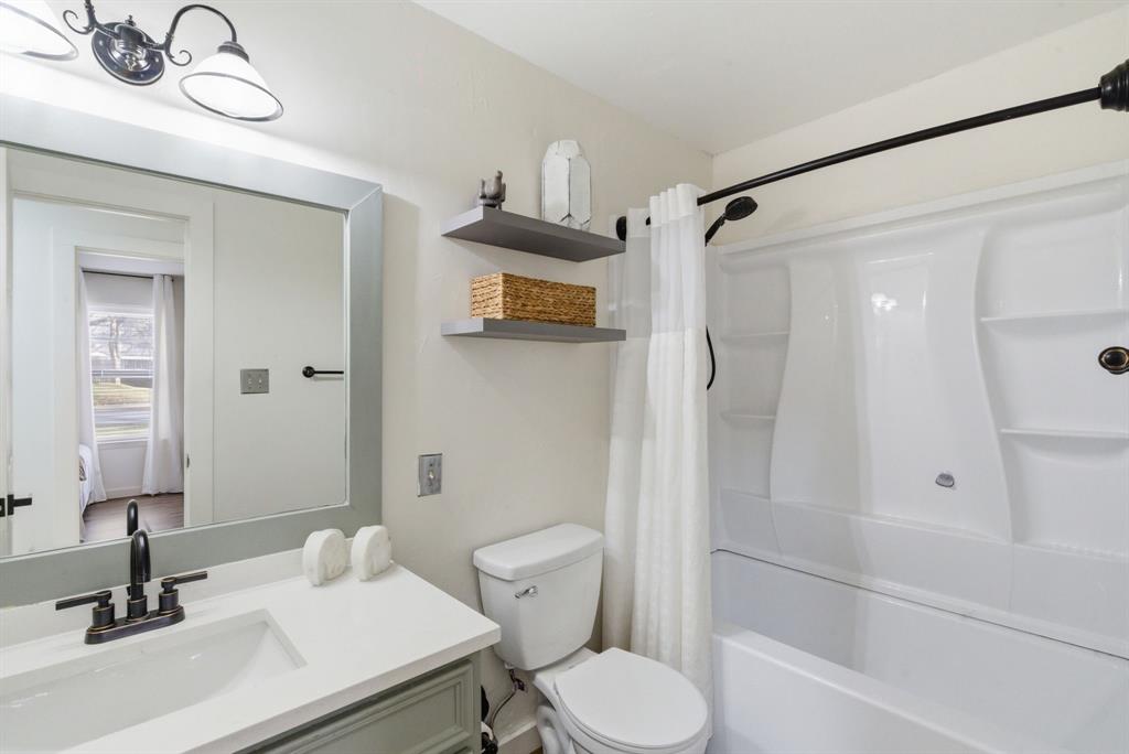 1008 Royal Lane Graham, TX 76450 - Photo 12 of 22 a bathroom with a sink toilet and shower