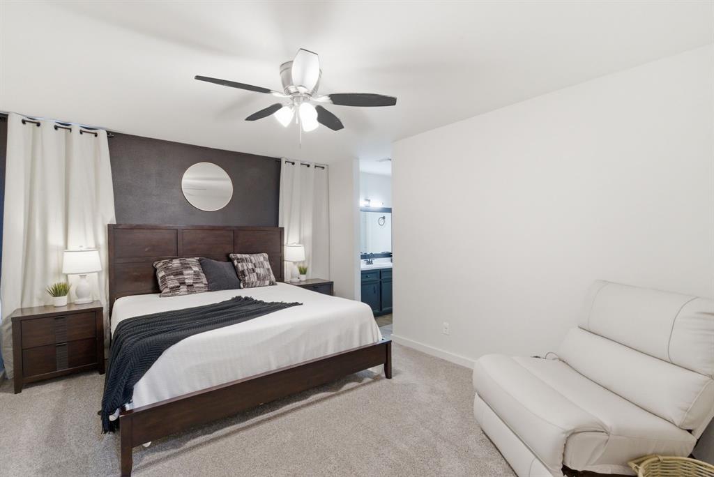 1008 Royal Lane Graham, TX 76450 - Photo 13 of 22 a bedroom with a bed and a chandelier