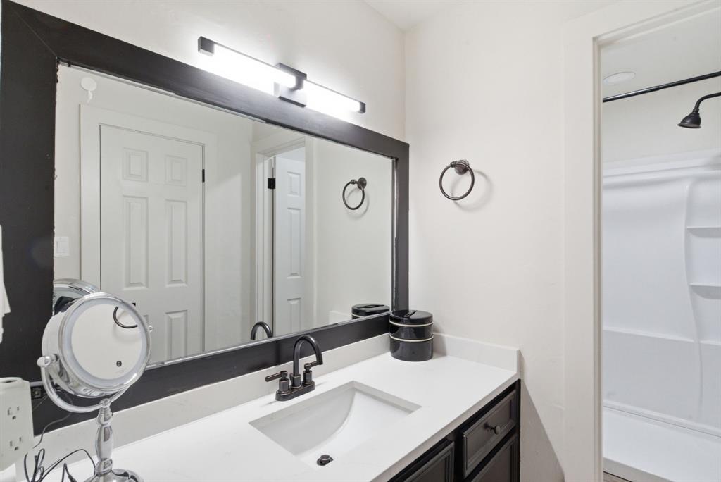1008 Royal Lane Graham, TX 76450 - Photo 14 of 22 a bathroom with a sink vanity and a mirror