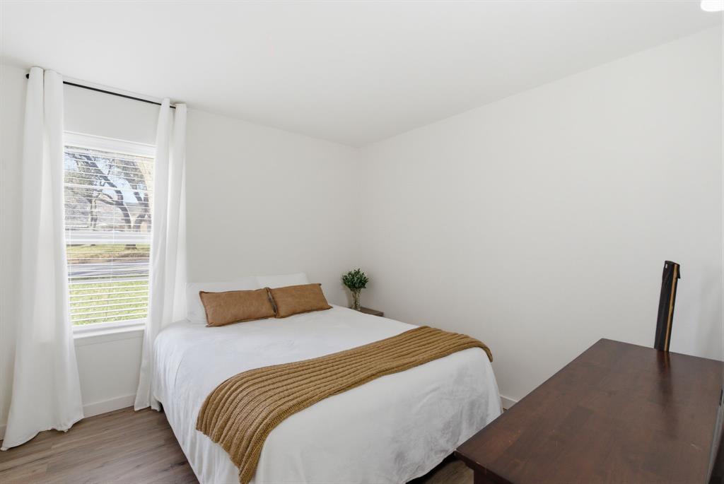 1008 Royal Lane Graham, TX 76450 - Photo 10 of 22 a bedroom with a bed and wooden floor