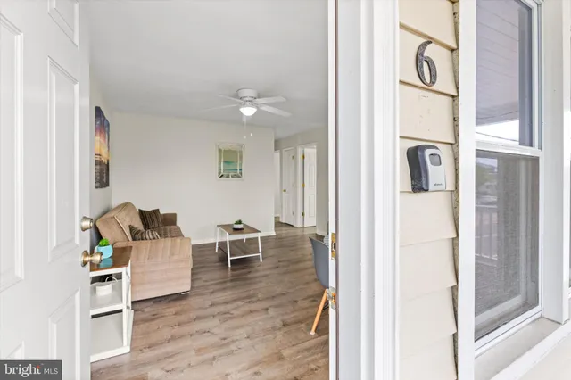 a kitchen with granite countertop a sink a stove a refrigerator and white cabinets