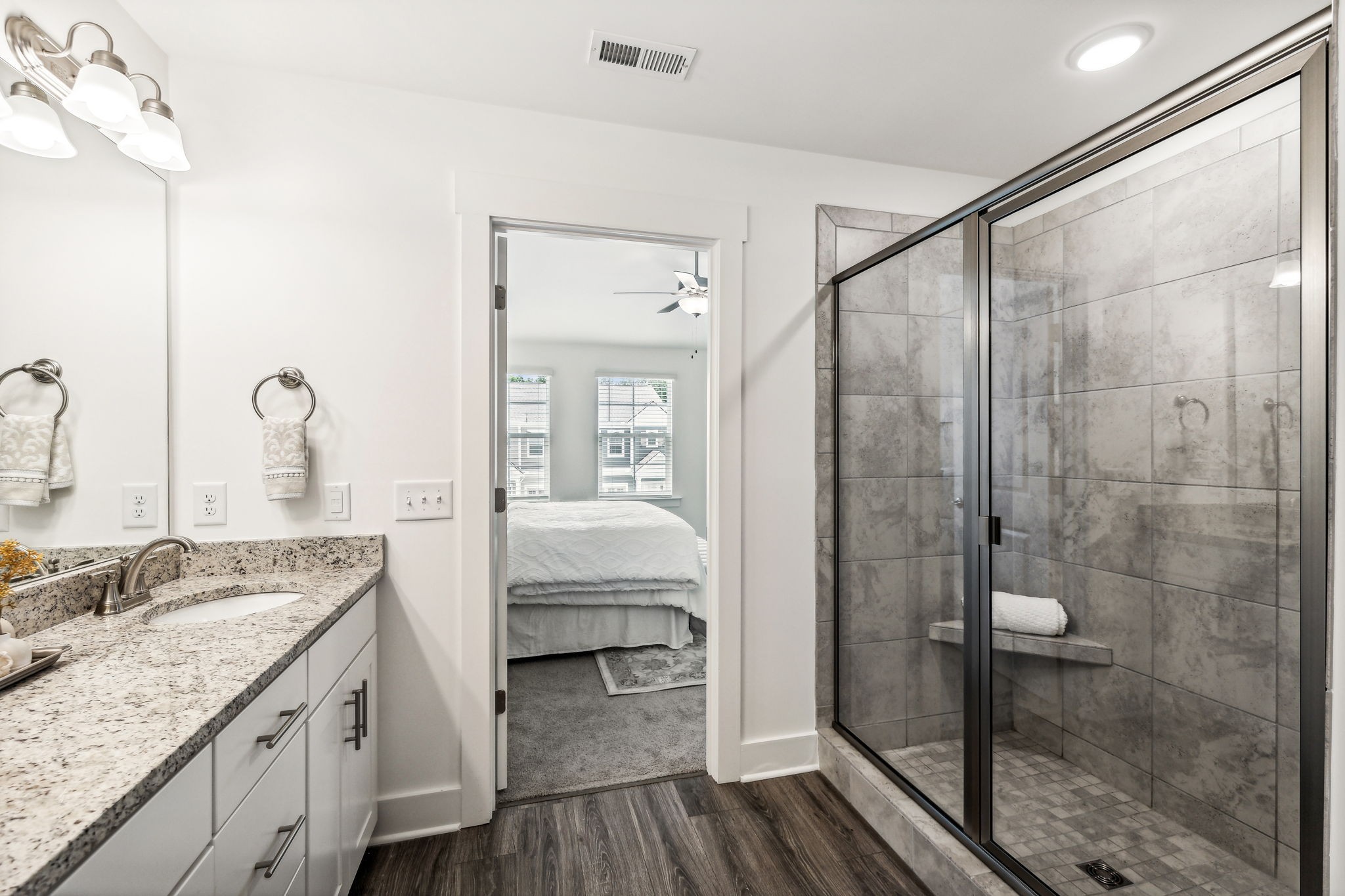 7144 Gracious Drive Franklin, TN 37064 - Photo 25 of 32 a en suite bathroom with a granite countertop sink mirror and shower