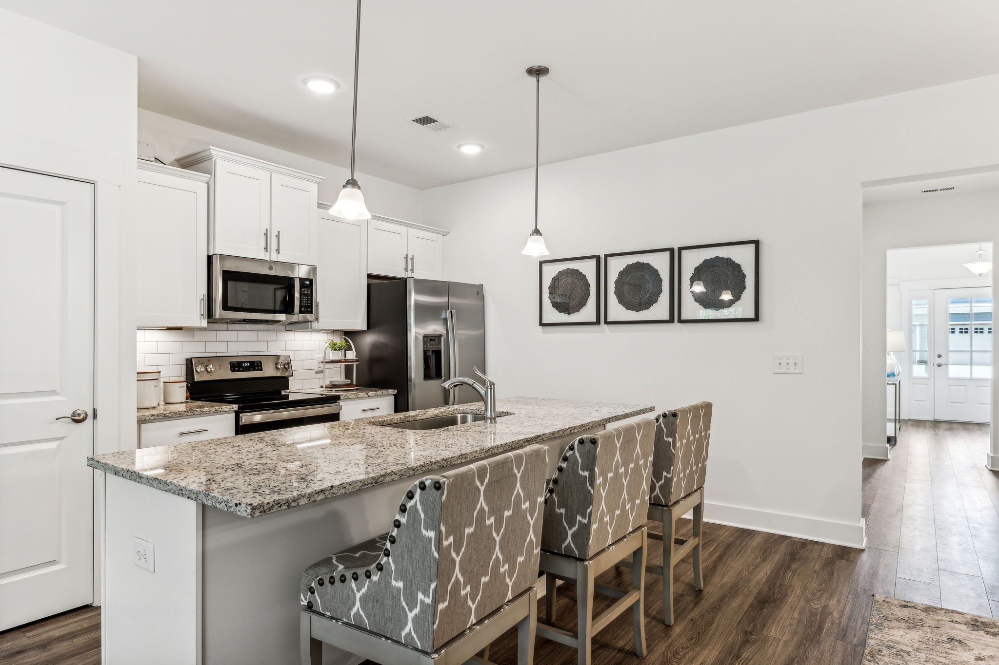 7144 Gracious Drive Franklin, TN 37064 - Photo 7 of 32 a kitchen with stainless steel appliances granite countertop a stove a sink and a microwave